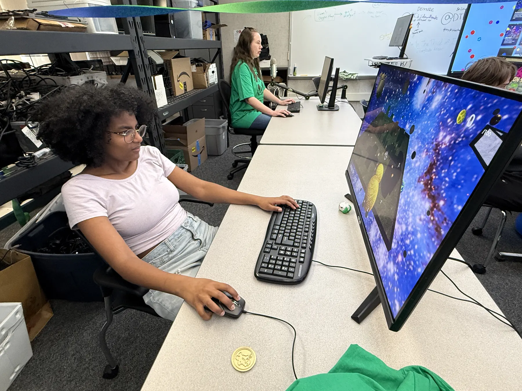 A student playtesting Duck Ship at a club PC